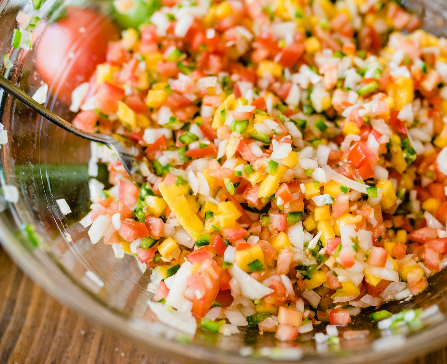 a glass bowl filled with chopped up vegetables