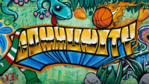 a graffiti wall with a dragon and a basketball on it